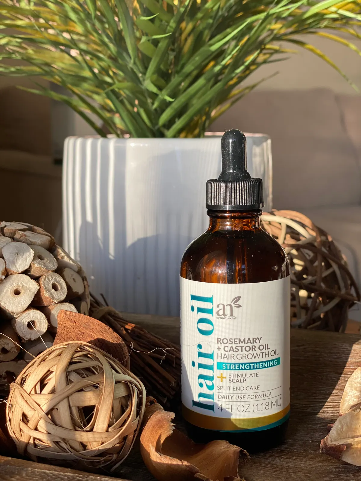 A bottle of castor oil, the key ingredient in the oil cleansing method, styled with botanical elements.